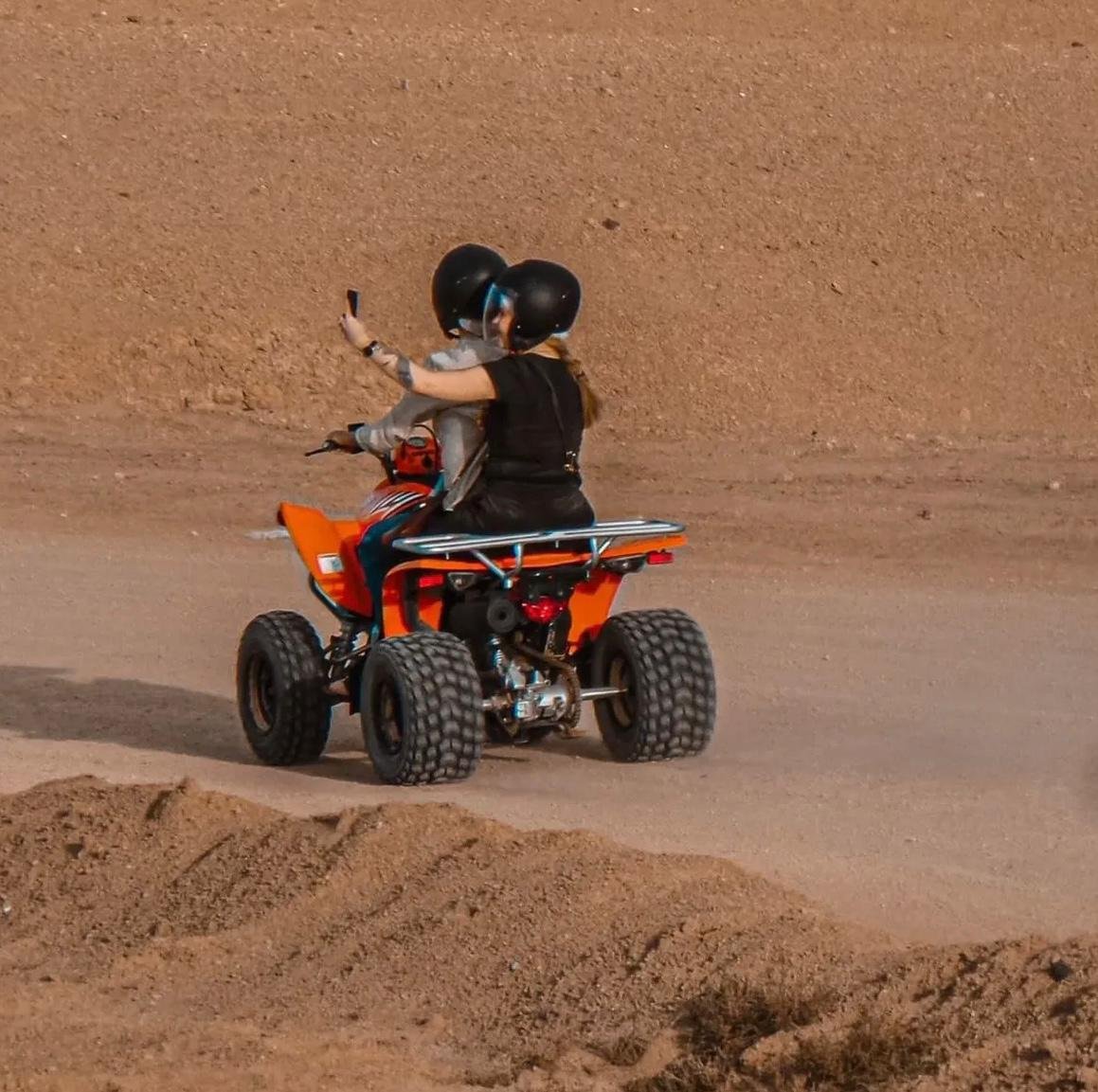 Two people sharing one quad in the Agafay desert